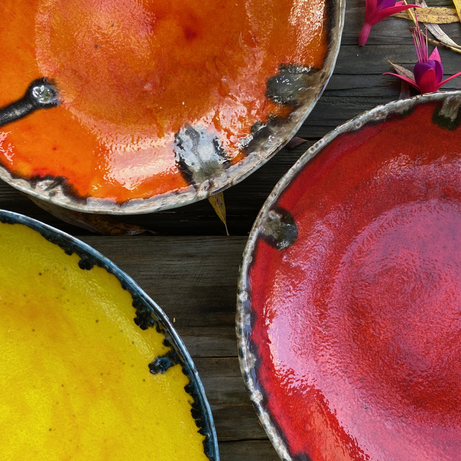 close up of 3 ceramic dishes in different colours
