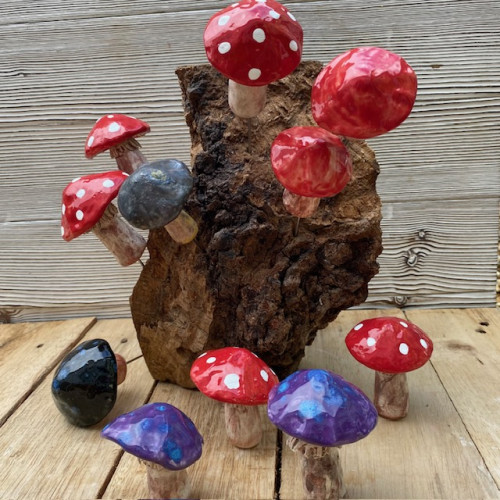 ceramic mushrooms displayed on a decorative piece of wood